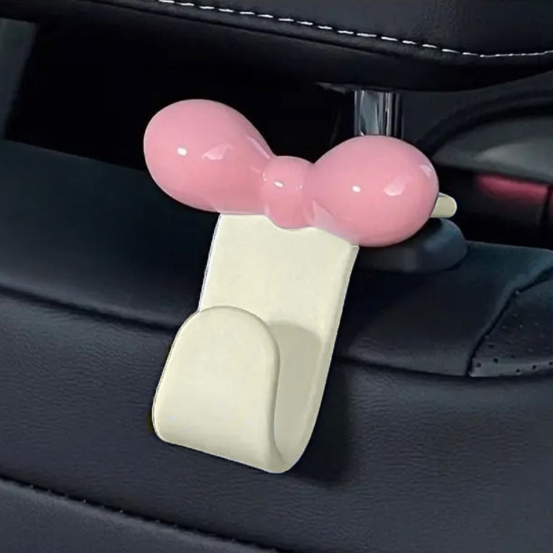 Travel Accessories Store - ミニマリストなボウ型車用後部座席吊り下げフック、実用的な収納アクセサリー、ハンドバッグ、軽食、車内旅行用品用